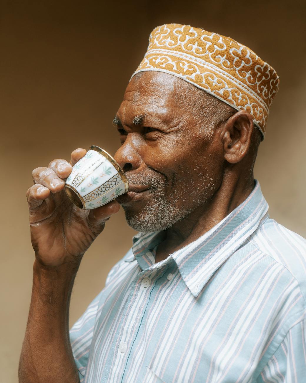 elderly man in zanzibar enjoying tea
